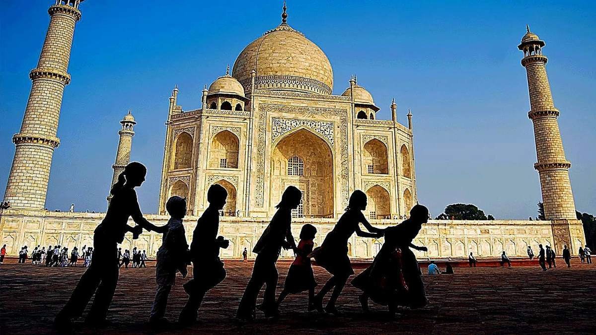 Family silhouette in front of the Taj Mahal, group tour tempo traveller by Awadh Travels