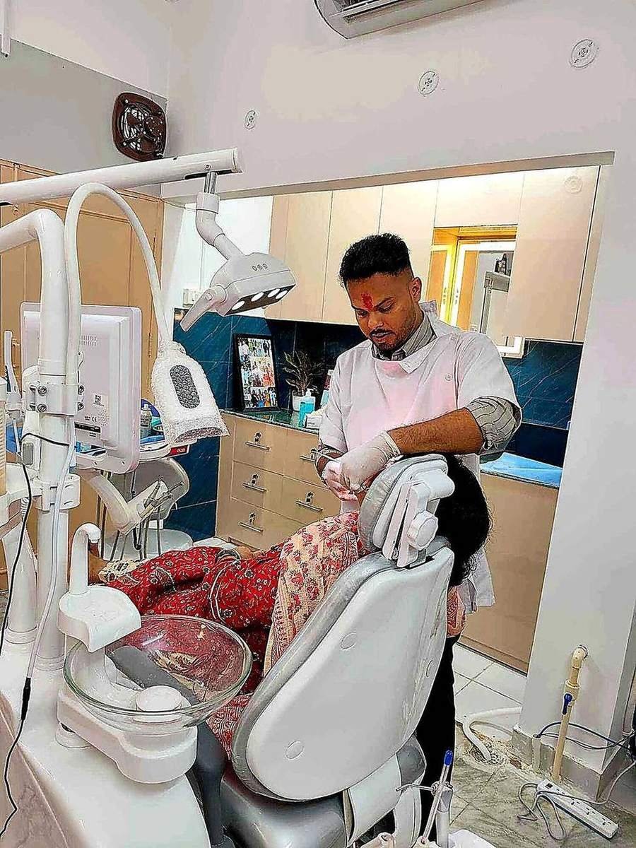 Dr. Kartikey treating a patient on the dental chair at Dental Arc, Aliganj