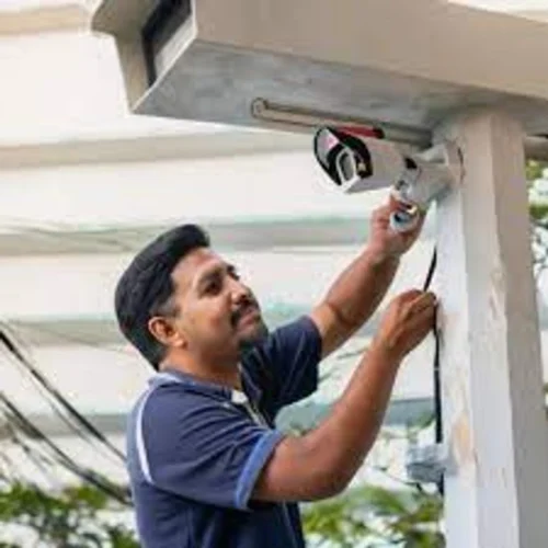 Falcon Eye technician installing a CCTV camera on an outdoor pillar, Kursi Road, Lucknow