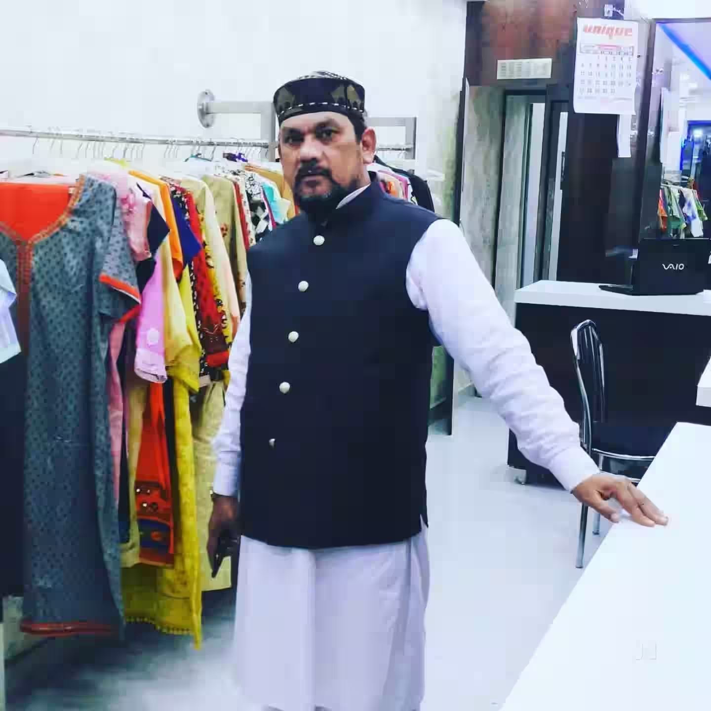 Owner in studio with garment racks