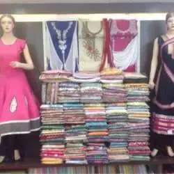 Kurti and fabric stack display at the boutique