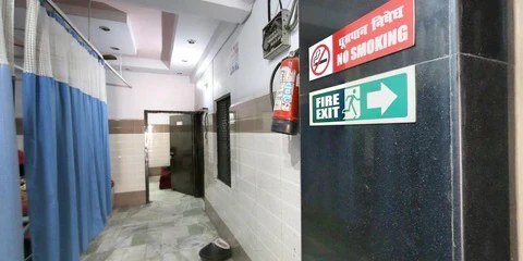 Clean hospital corridor with fire-exit signage at the maternity centre