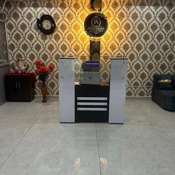 Reception desk with Pravarshi Aesthetics branding at LDA Colony clinic