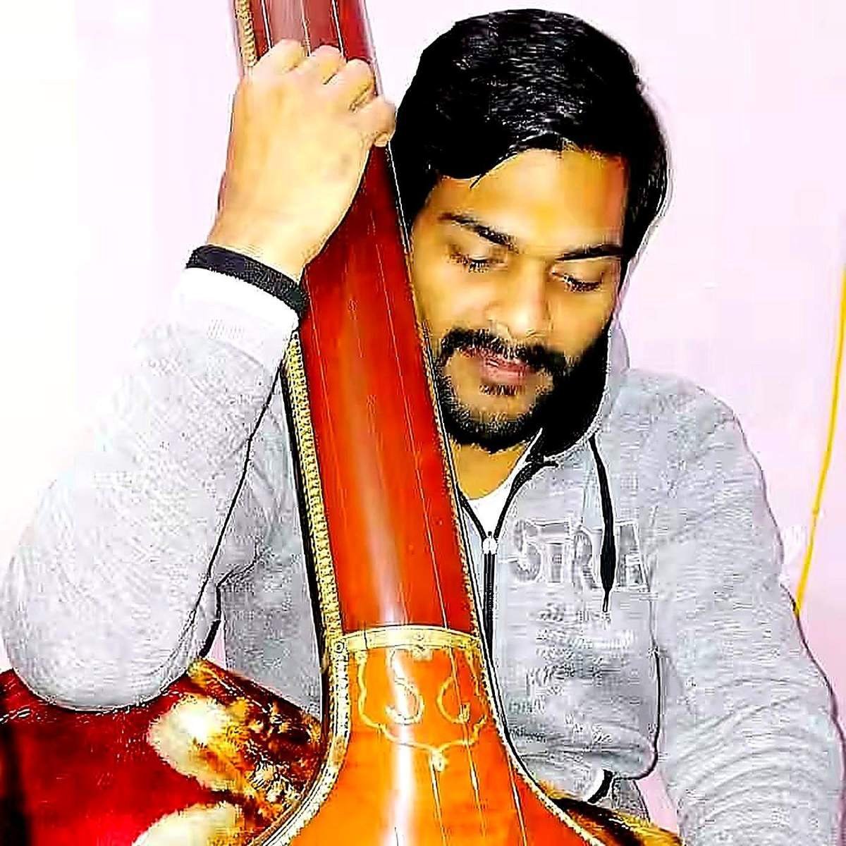 Student practising tanpura during a classical music session