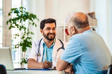 Dr. Zaidi examining a senior patient at the clinic