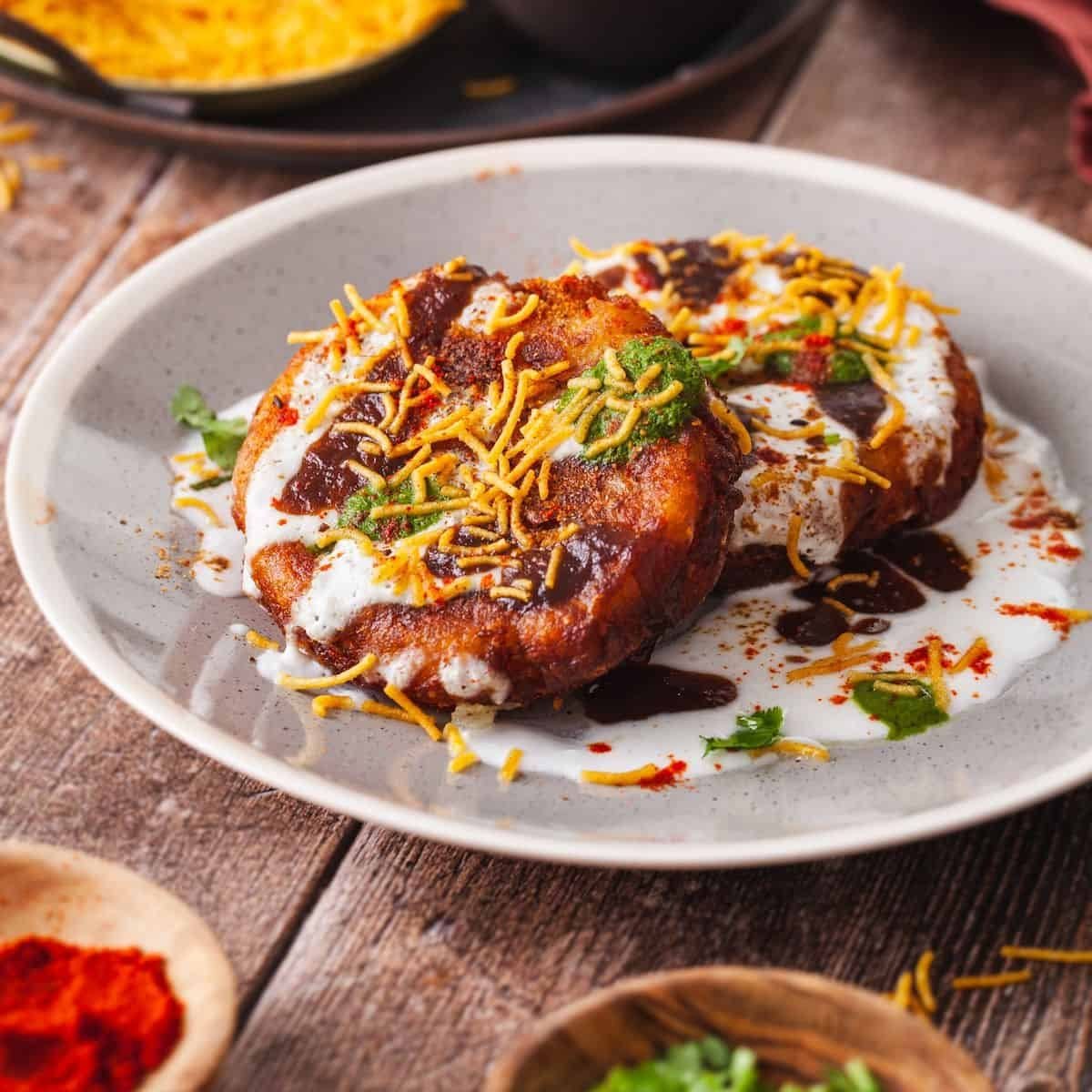 Aloo tikki chaat plate with yogurt and chutneys — best chaat in Hazratganj Lucknow