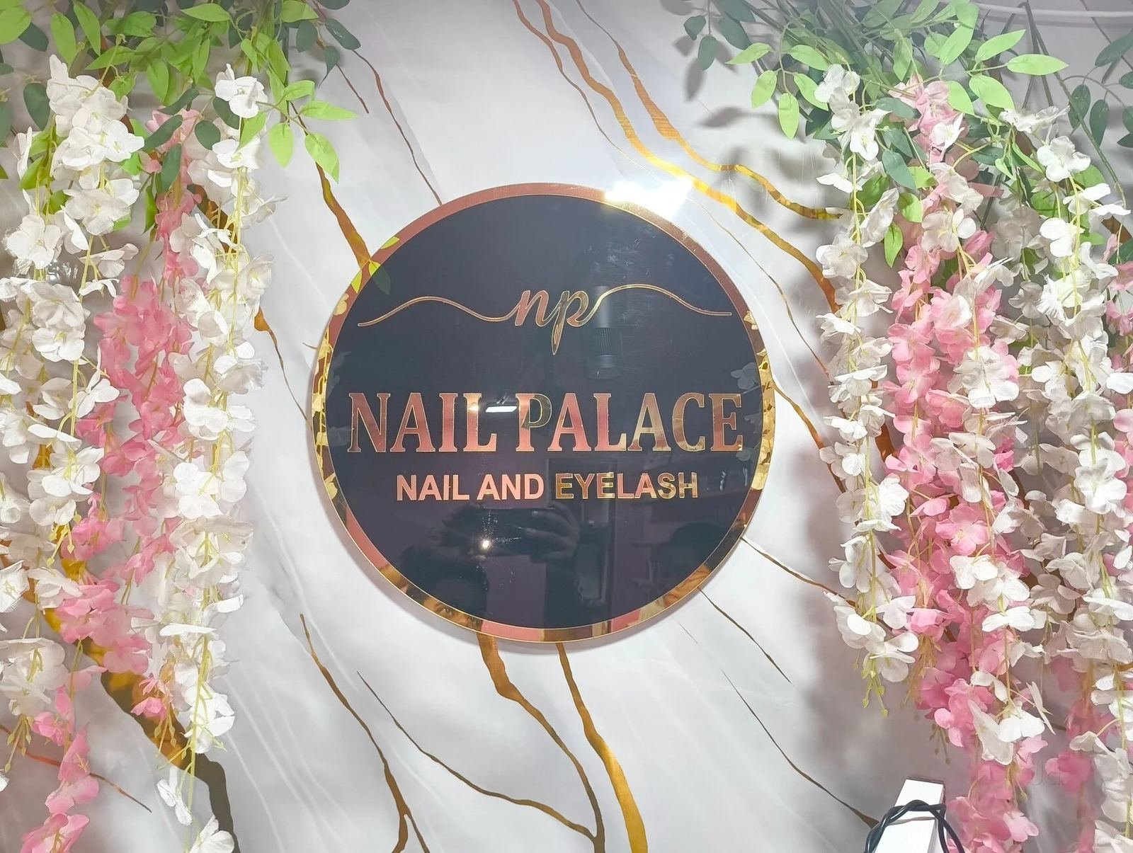 The Nail Palace logo wall with floral decor at Charbagh studio Lucknow