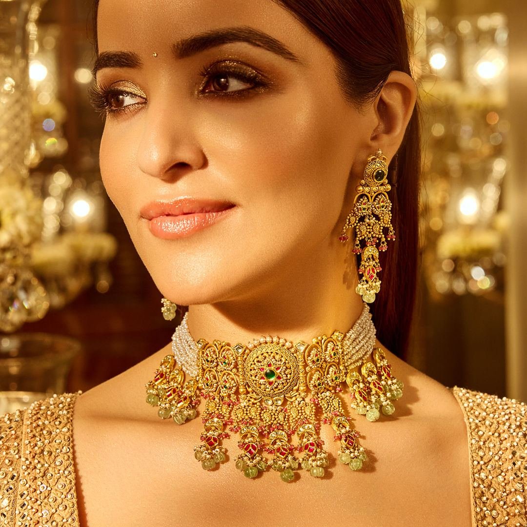 Model wearing bridal gold choker and earrings